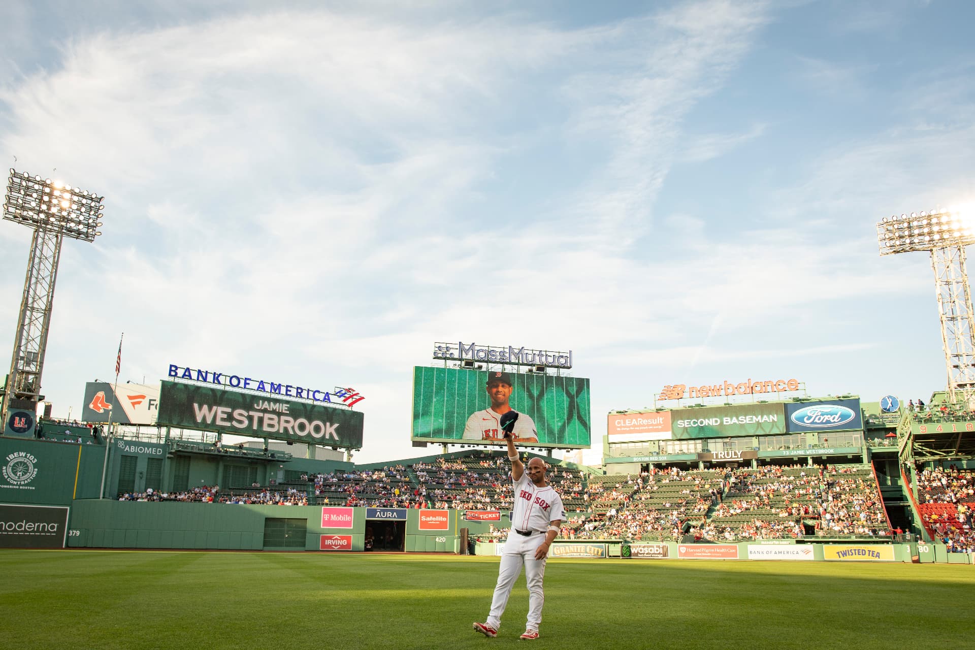 Jamie Westbrook raising his cap at Fenway Park with his name on the scoreboard